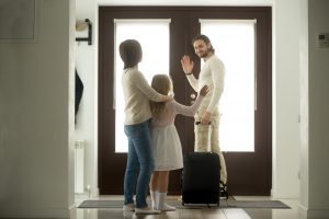 Father smiling waving goodbye to ex and daughter